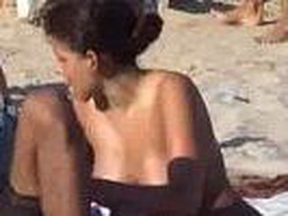 Hot latin chick spied on beach with hidden cam, worthy looking girl with pleasant big boobies sitting down, she gets up and quick glimpse of pussy, hot bitch.