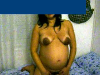 This preggo wife with charming cinnamon skin is about 8 months pregnant. She shows her big belly and her breasts are bare - her areolas are very darksome and large.