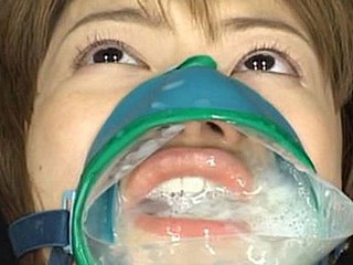 Ruri Anno is fastened down and takes cumshots into this cum facial mask over her mouth and nose.